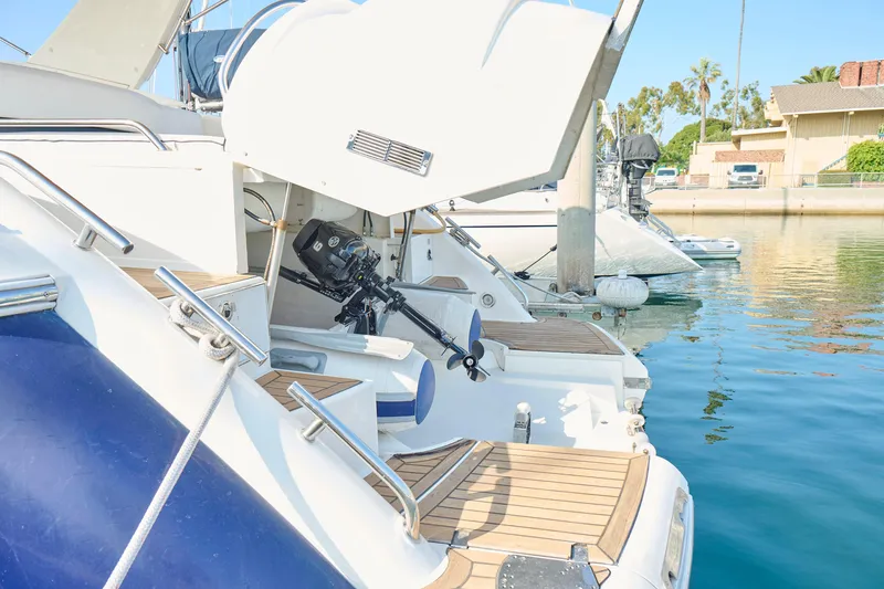 Slide: The Image of Fairline 43 yacht from 2001 docked, showcasing open engine compartment and wooden deck. - 50