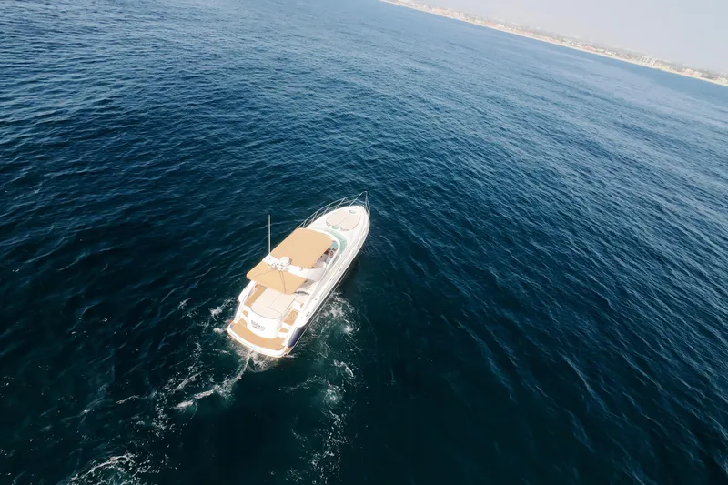 Slide: The Image of Aerial view of 2001 Fairline 43 yacht cruising on open sea. - 52
