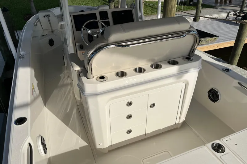 Slide: The Image of 2024 Boston Whaler 250 Dauntless boat interior with helm and seating area. - 12