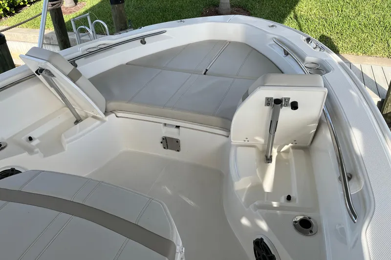 Slide: The Image of 2024 Boston Whaler 250 Dauntless boat interior with cushioned seating and storage compartments. - 13