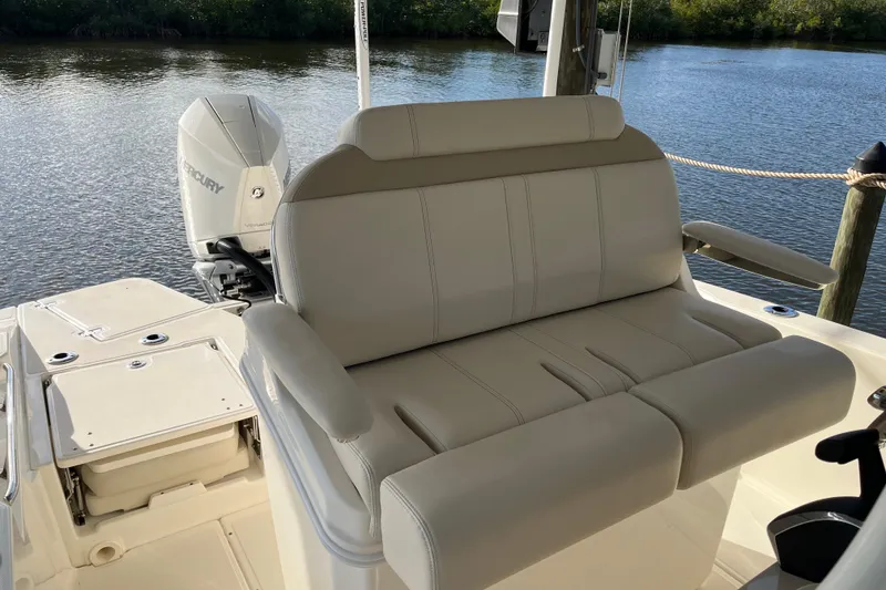 Slide: The Image of 2024 Boston Whaler 250 Dauntless boat interior with comfortable seating and Mercury engine. - 14