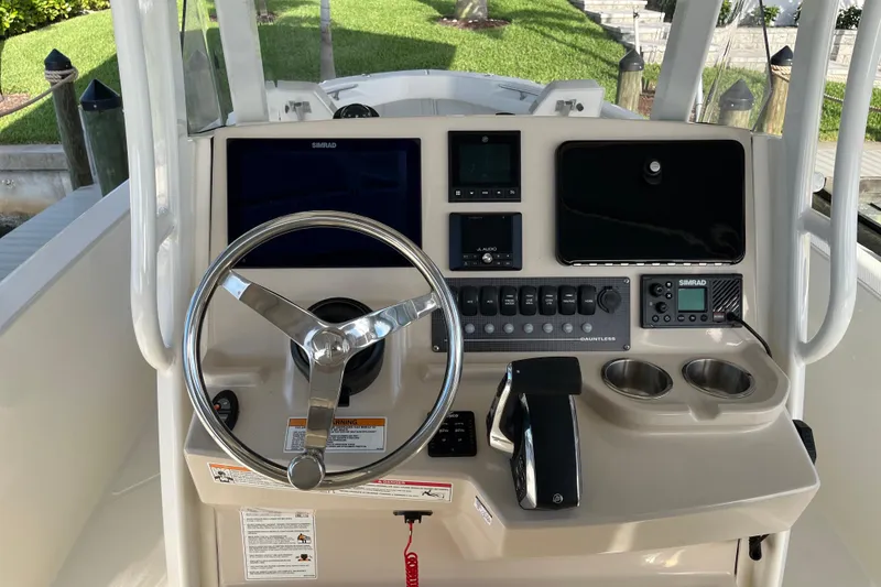 Slide: The Image of 2024 Boston Whaler 250 Dauntless helm with steering wheel and control panel. - 3