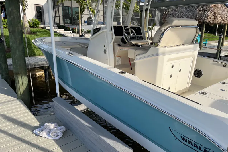 Slide: The Image of 2024 Boston Whaler 250 Dauntless boat docked, showcasing sleek design and modern features. - 4