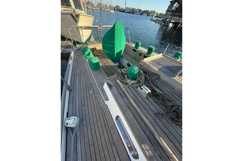 Slide: The Image of Deck of 2007 Chuck Burns Custom 49' Schooner with green covers and ropes. - 11