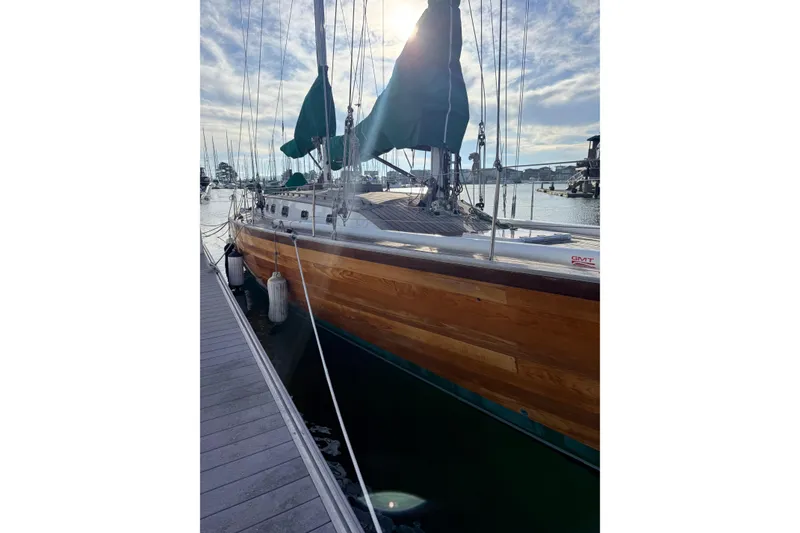 Slide: The Image of Custom 49' Schooner by Chuck Burns, 2007, docked with wooden hull and green sails. - 12