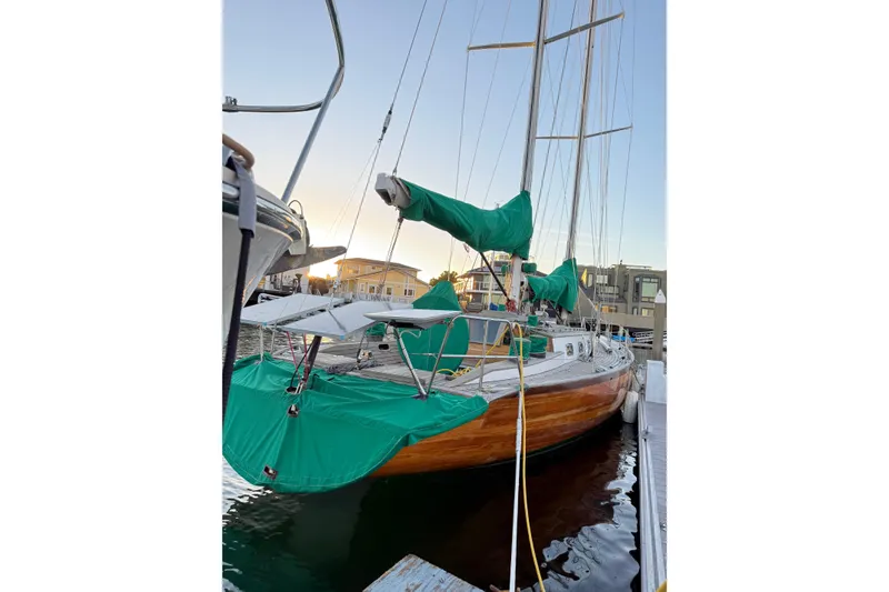 Slide: The Image of Custom 49' Schooner by Chuck Burns, 2007, docked with green covers, wooden hull. - 18