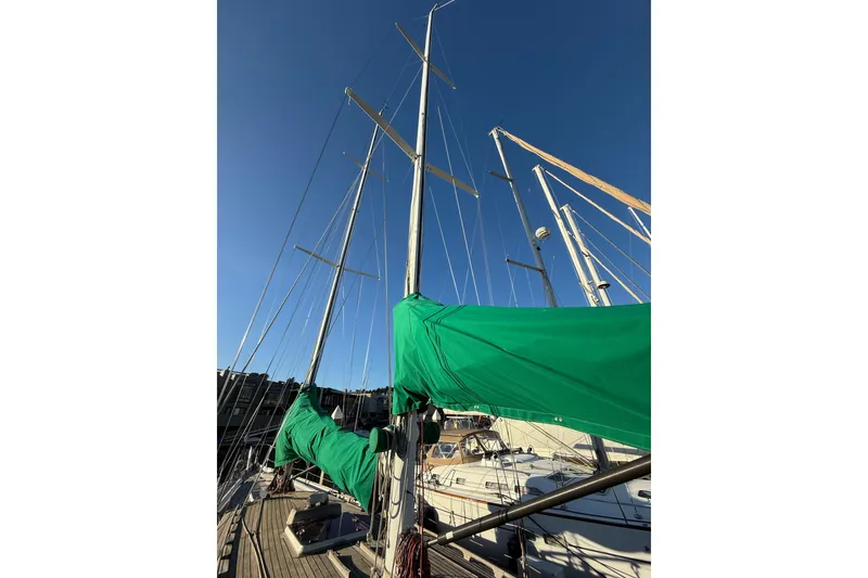 Slide: The Image of 49' Chuck Burns Custom Schooner, 2007, with green sails against a clear blue sky. - 19
