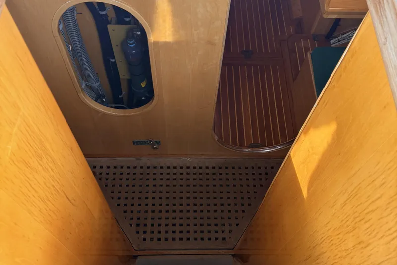 Slide: The Image of Interior view of a 2007 Chuck Burns Custom 49' Schooner, showcasing wooden flooring and paneling. - 25
