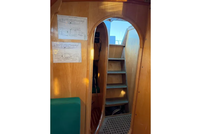 Slide: The Image of Interior of 2007 Chuck Burns Custom 49' Schooner with wooden stairs and design plans. - 26
