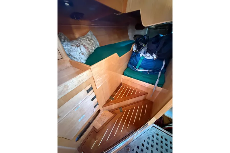 Slide: The Image of Interior of 2007 Chuck Burns Custom 49' Schooner with wooden steps and cozy sleeping area. - 31