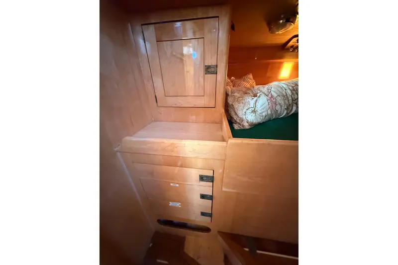 Slide: The Image of Interior of 2007 Chuck Burns Custom 49' Schooner with wooden cabinetry and cozy bedding. - 33