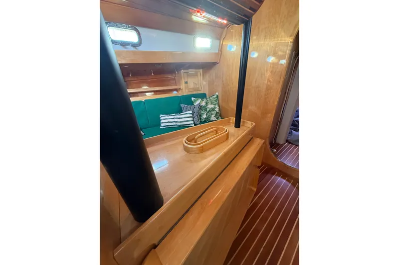 Slide: The Image of Interior of 2007 Chuck Burns Custom 49' Schooner with wooden finish and green seating. - 34