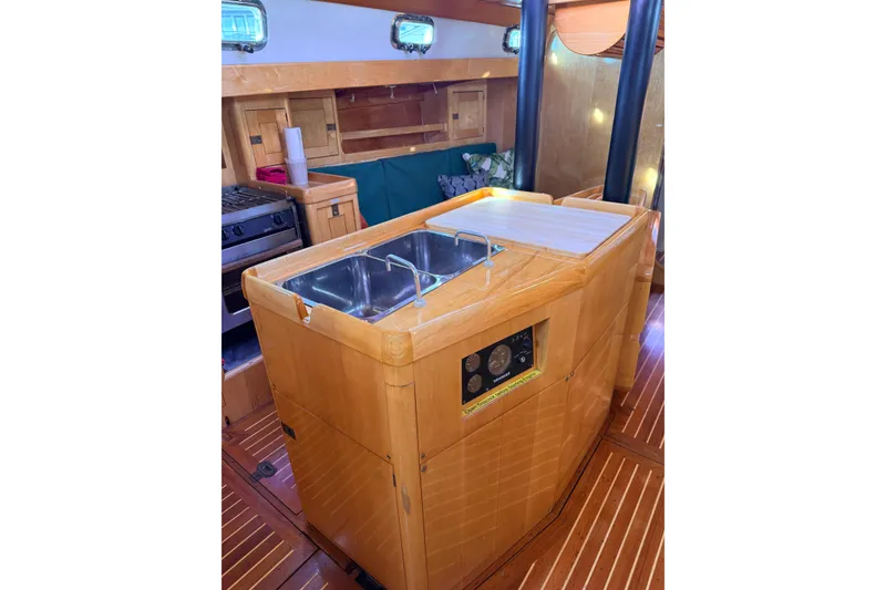 Slide: The Image of Interior of 2007 Chuck Burns Custom 49' Schooner with wooden cabinetry and dual sink. - 38
