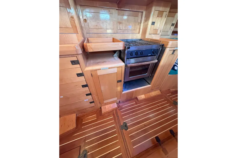 Slide: The Image of Wooden interior of 2007 Chuck Burns Custom 49' Schooner with stove and cabinetry. - 40