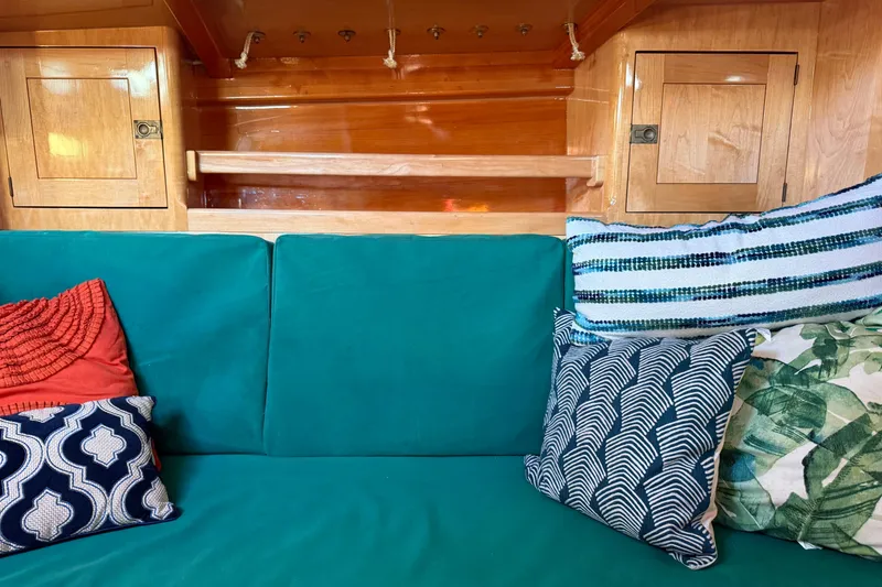 Slide: The Image of Interior of 2007 Chuck Burns Custom 49' Schooner with colorful cushions and wooden cabinetry. - 42