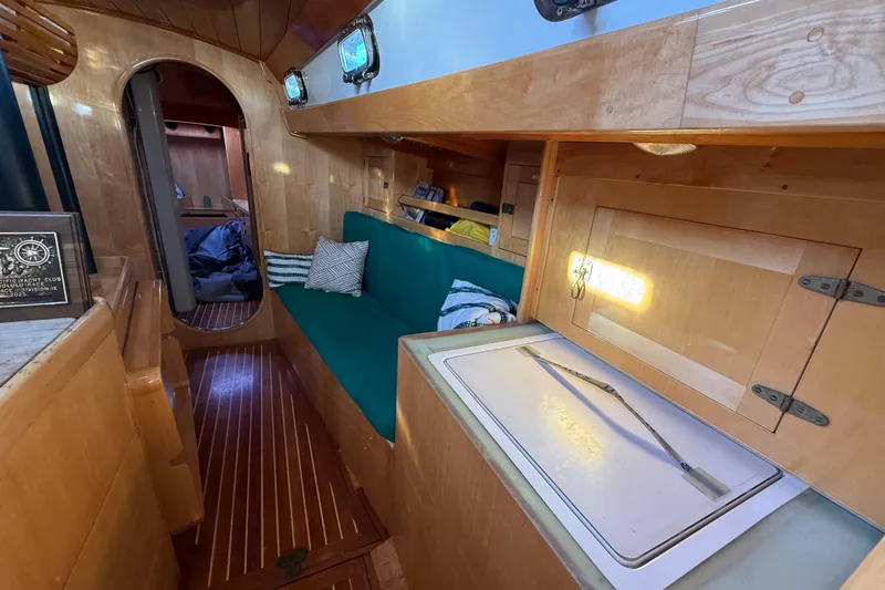 Slide: The Image of Interior of a 2007 Chuck Burns Custom 49' Schooner with wooden finishes and cozy seating. - 43