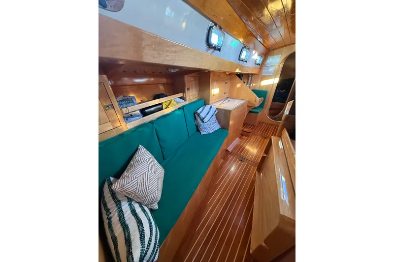 Slide: The Image of Luxurious interior of 2007 Chuck Burns Custom 49' Schooner with wooden finish and green seating. - 44