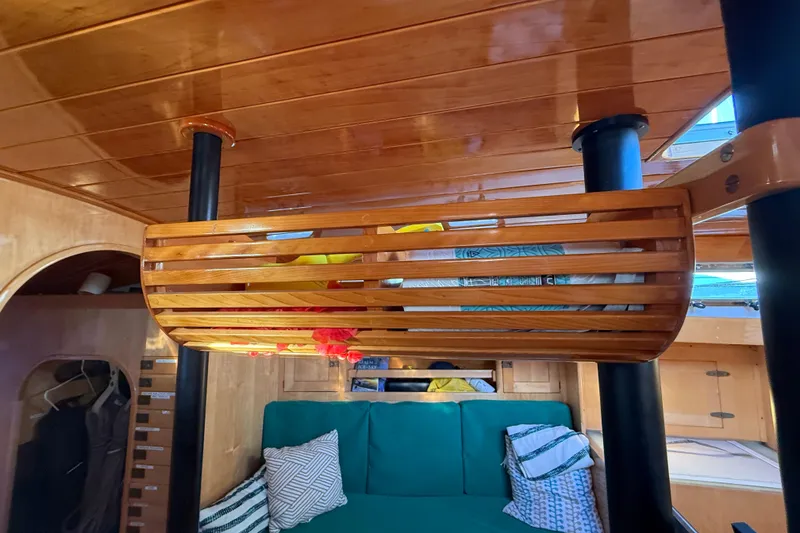 Slide: The Image of Interior of 2007 Chuck Burns Custom 49' Schooner with wooden ceiling and cozy seating area. - 46