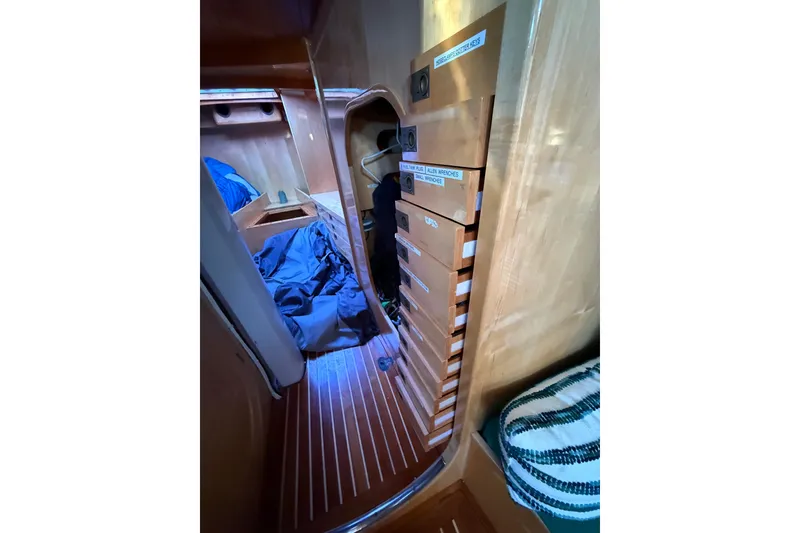 Slide: The Image of Interior of 2007 Chuck Burns Custom 49' Schooner with wooden cabinetry and cozy sleeping area. - 47