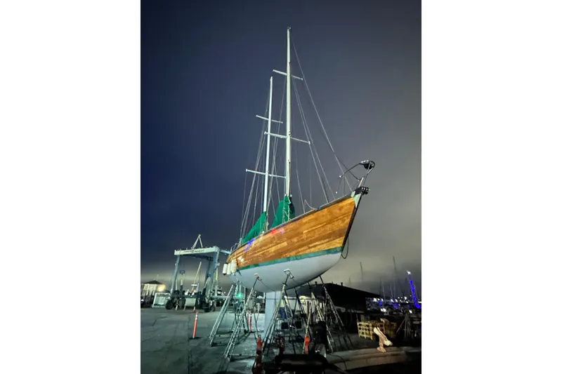 Slide: The Image of Custom 49' Schooner by Chuck Burns, 2007, docked at night under a cloudy sky. - 5