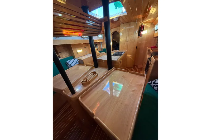 Slide: The Image of Interior of 2007 Chuck Burns Custom 49' Schooner with polished wood and cozy seating. - 51