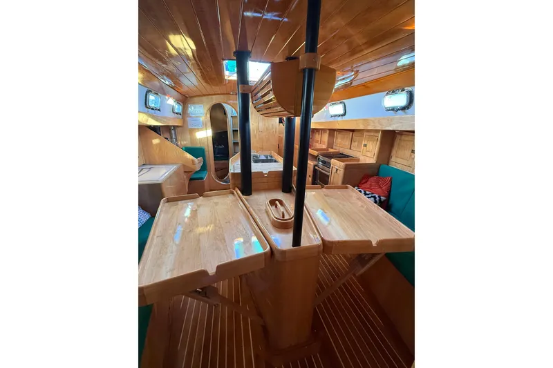 Slide: The Image of Interior of 2007 Chuck Burns Custom 49' Schooner with wooden finishes and cozy seating. - 52