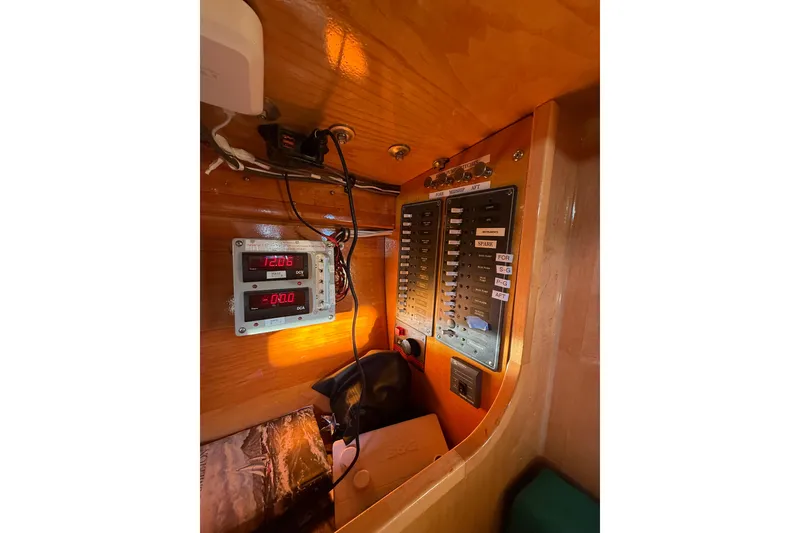 Slide: The Image of Electrical panel inside 2007 Chuck Burns Custom 49' Schooner, featuring gauges and switches. - 55