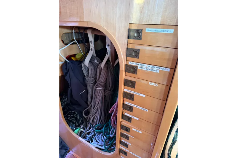 Slide: The Image of Storage area with ropes and labeled drawers on a 2007 Chuck Burns Custom 49' Schooner. - 57