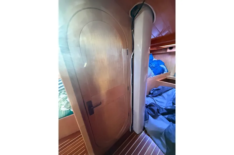 Slide: The Image of Wooden interior of 2007 Chuck Burns Custom 49' Schooner, featuring a door and storage area. - 59