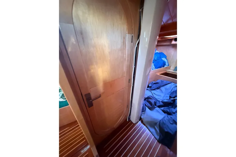 Slide: The Image of Interior of 2007 Chuck Burns Custom 49' Schooner with wooden door and cozy cabin space. - 60