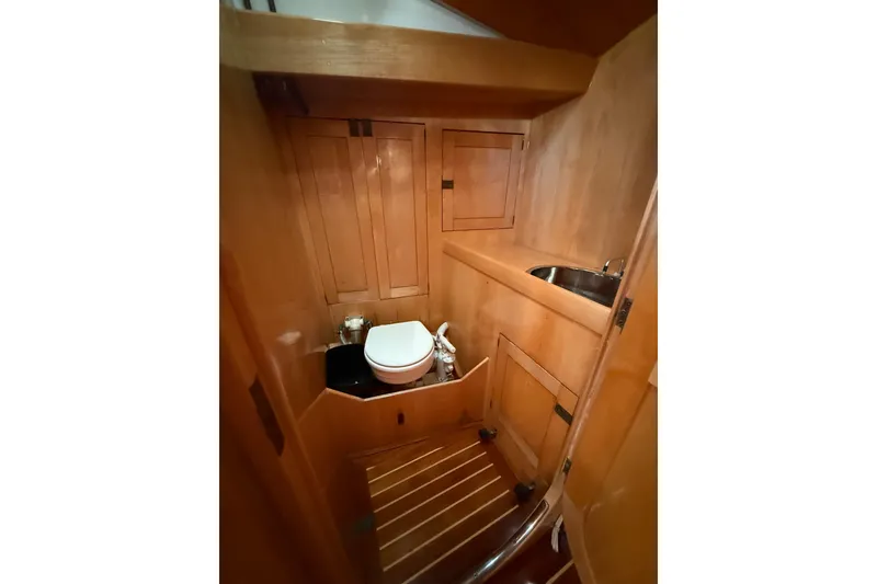 Slide: The Image of Wood-paneled bathroom in 2007 Chuck Burns Custom 49' Schooner with toilet and sink. - 61