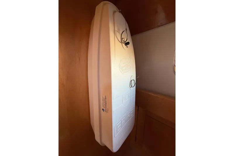 Slide: The Image of Wall-mounted white surfboard inside Chuck Burns Custom 49' Schooner, 2007 model. - 68