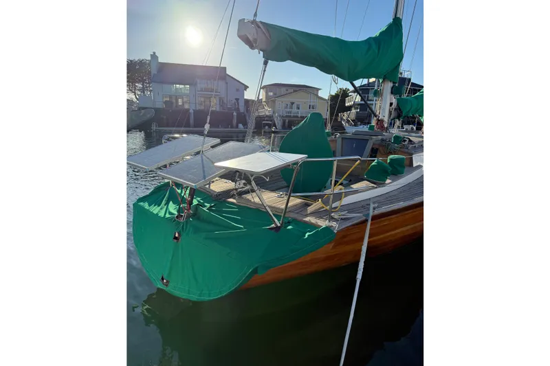 Slide: The Image of Custom 49' Schooner by Chuck Burns, 2007, docked with green covers and solar panels. - 7