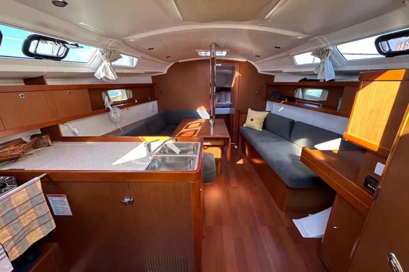 Slide: The Image of Interior of 2015 Beneteau Oceanis 37 sailboat with modern wood finish and seating area. - 13