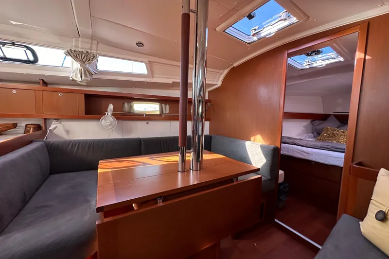 Slide: The Image of Interior of 2015 Beneteau Oceanis 37 sailboat, featuring cozy seating and a cabin. - 14