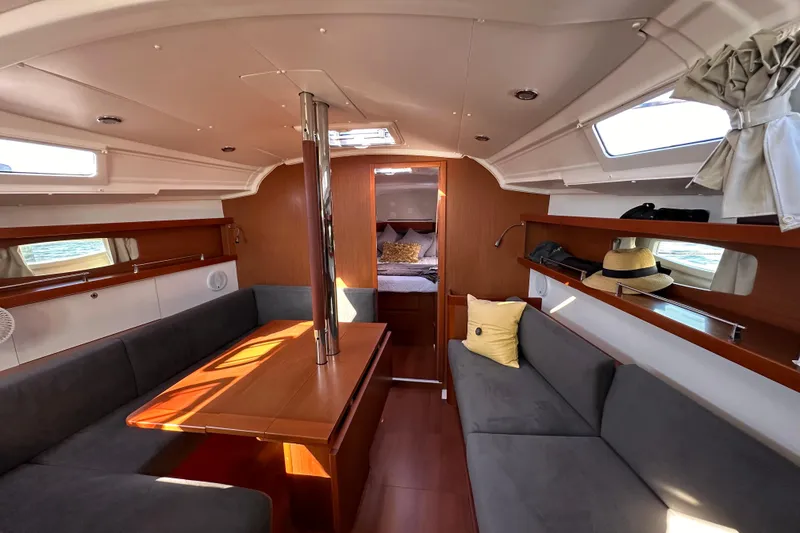 Slide: The Image of Interior of 2015 Beneteau Oceanis 37 sailboat with cozy seating and wooden finishes. - 16