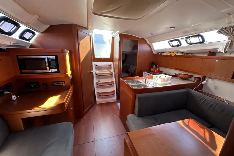 Slide: The Image of Interior of 2015 Beneteau Oceanis 37 sailboat with modern kitchen and seating area. - 17