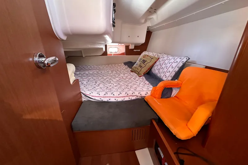 Slide: The Image of Cozy cabin interior of 2015 Beneteau Oceanis 37 with bed and orange seat. - 21
