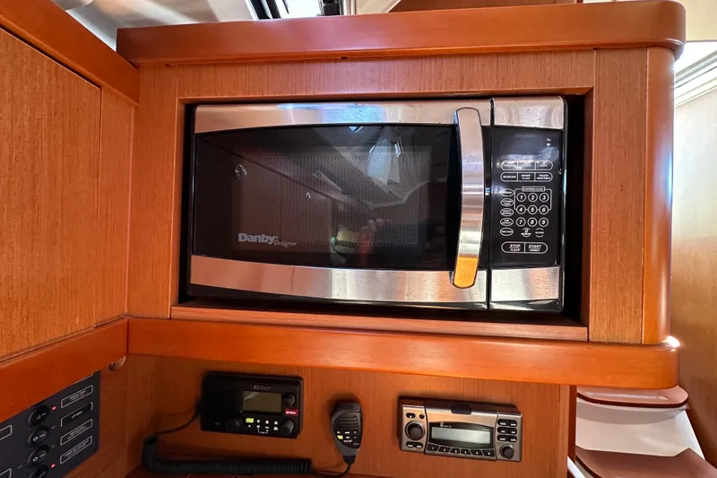 Slide: The Image of Microwave and control panel inside 2015 Beneteau Oceanis 37 yacht kitchen. - 22