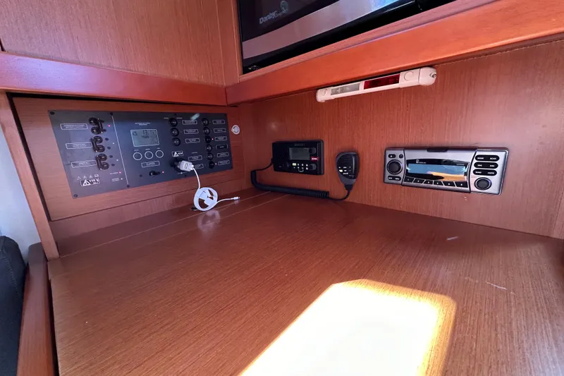 Slide: The Image of Control panel of a 2015 Beneteau Oceanis 37 yacht, featuring navigation and communication equipment. - 23