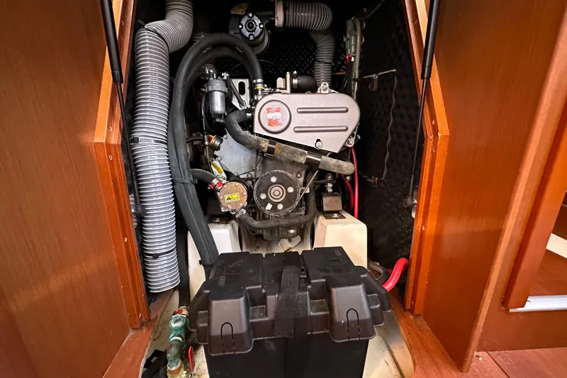 Slide: The Image of Engine compartment of a 2015 Beneteau Oceanis 37 sailboat, showcasing mechanical components. - 24