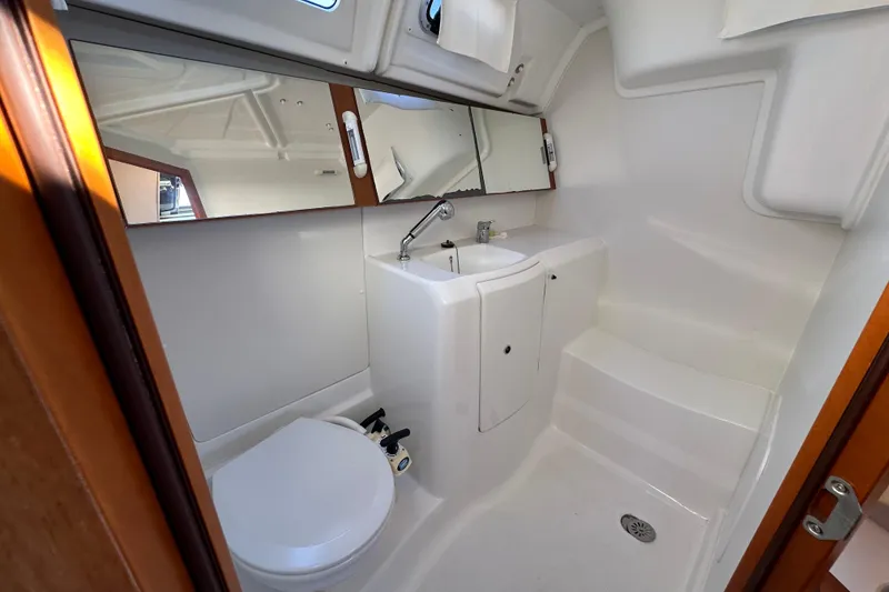 Slide: The Image of Beneteau Oceanis 37 yacht bathroom, 2015 model, featuring sink, toilet, and mirror. - 25