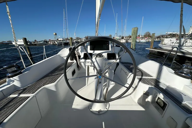 Slide: The Image of 2015 Beneteau Oceanis 37 sailboat cockpit with steering wheel, docked in marina. - 5
