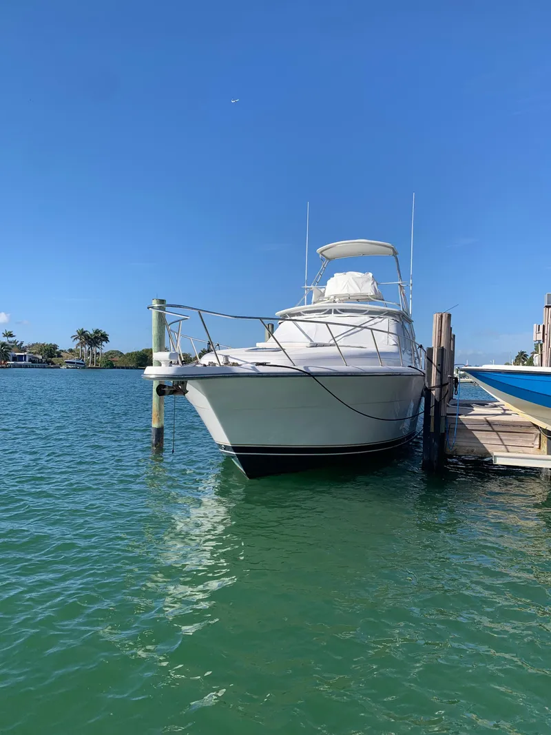 Slide: The Image of 1999 Tiara Yachts 43 Open docked on clear blue water. - 15