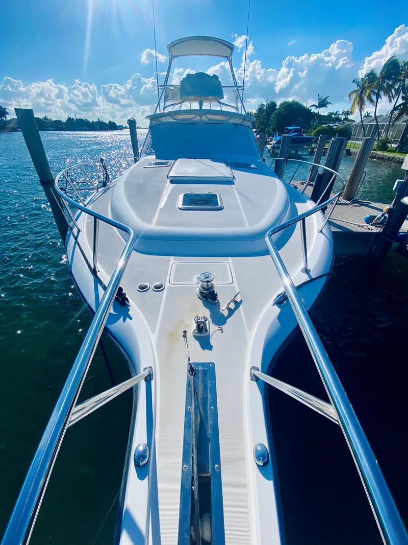 Slide: The Image of 1999 Tiara Yachts 43 Open docked, sunny day, clear blue sky, calm water. - 23