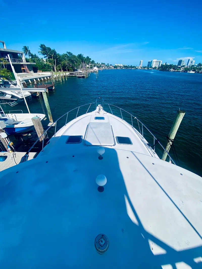 Slide: The Image of Tiara Yachts 1999 43 Open on a scenic waterfront, clear blue sky. - 25