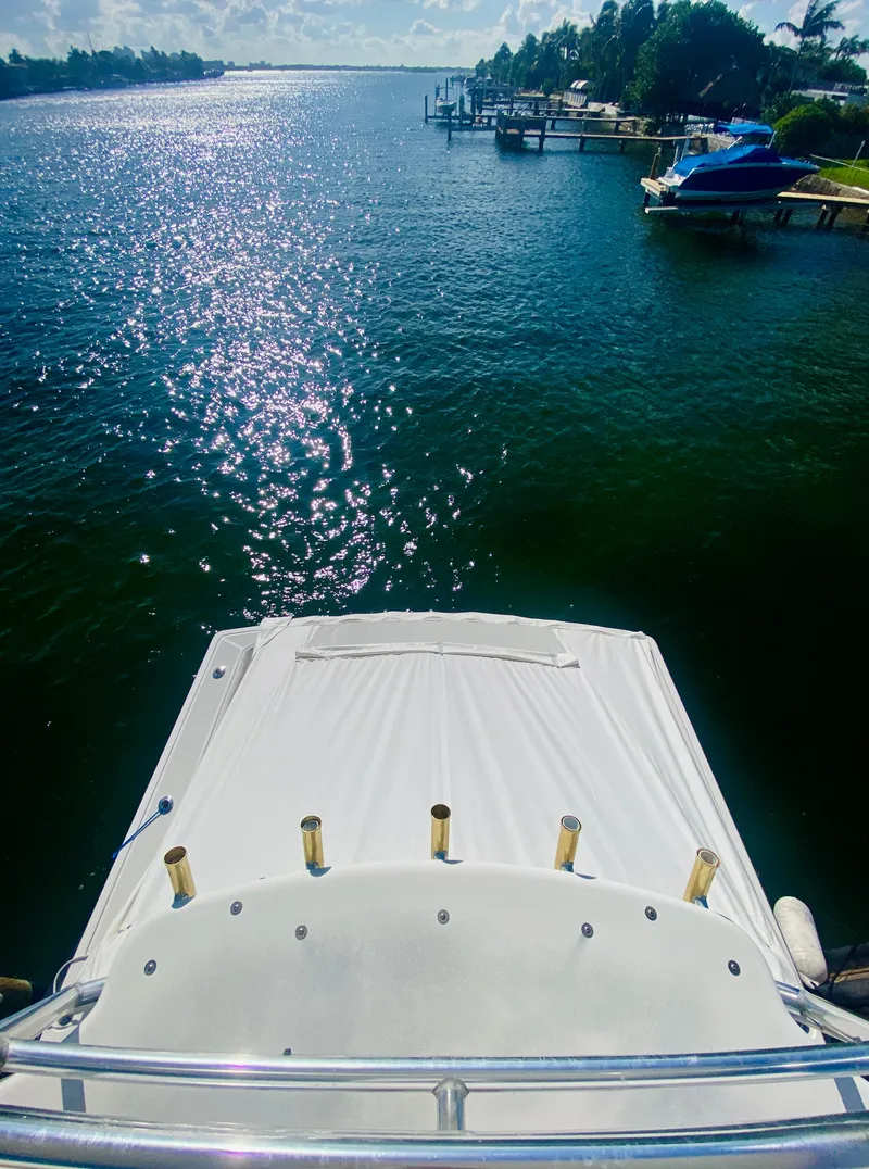 Slide: The Image of 1999 Tiara Yachts 43 Open on serene water with scenic shoreline view. - 32