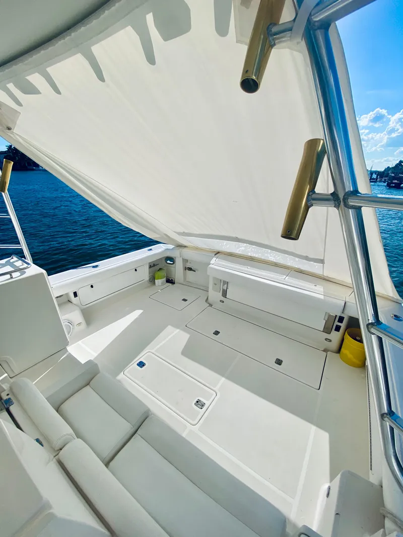Slide: The Image of 1999 Tiara Yachts 43 Open with spacious deck and canopy, overlooking serene waters. - 33