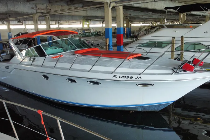 The Image of 1993 Wellcraft 4300 Portofino yacht docked in a marina, featuring sleek design and vibrant accents. - 0