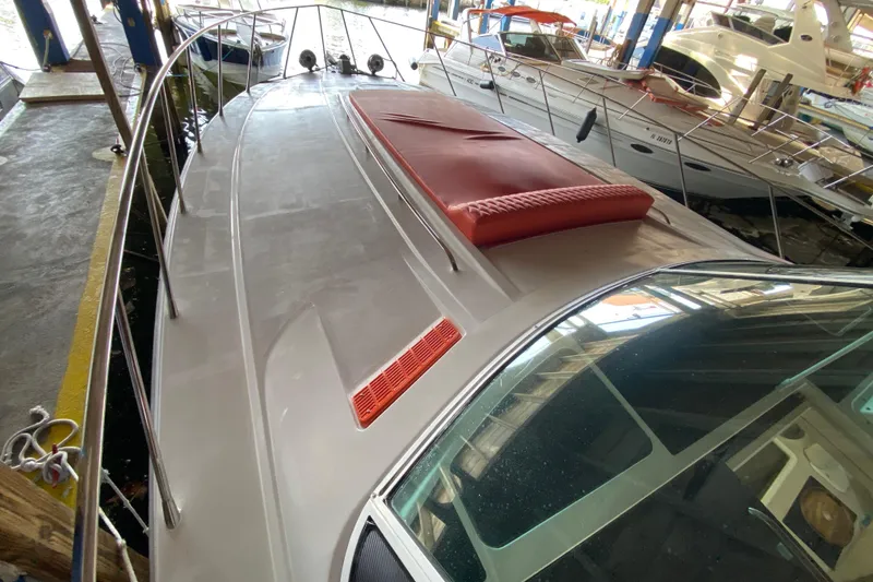 Slide: The Image of 1993 Wellcraft 4300 Portofino yacht docked in marina, featuring sleek deck design. - 11